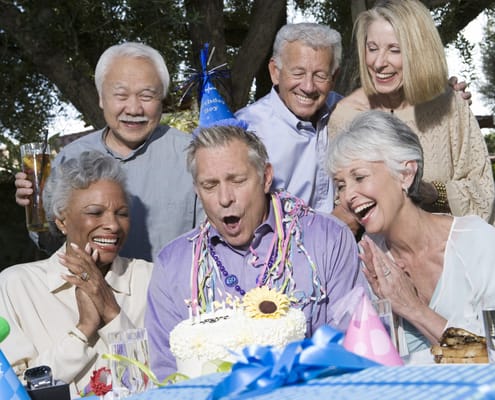 Residents celebrating a birthday with cake and smiles