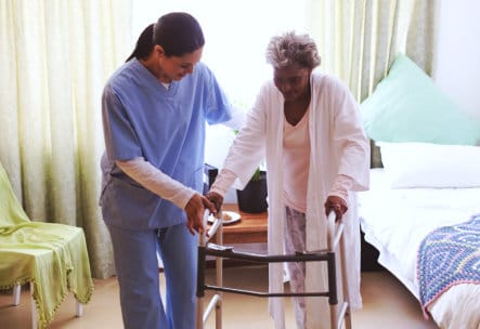 Caregiver assisting a resident in their room