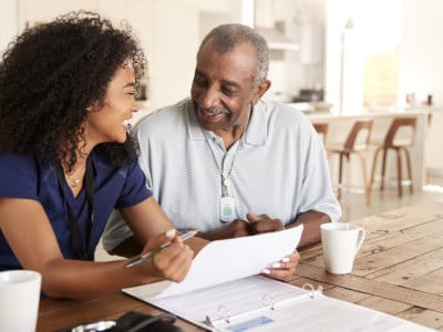 Staff member interacting with a resident at a table