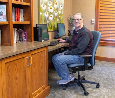 Resident using a computer in a cozy common area