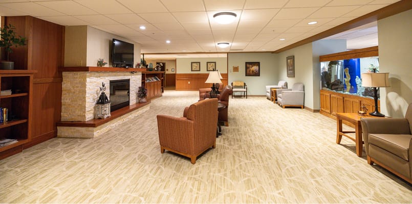 A spacious common area with seating and a fireplace