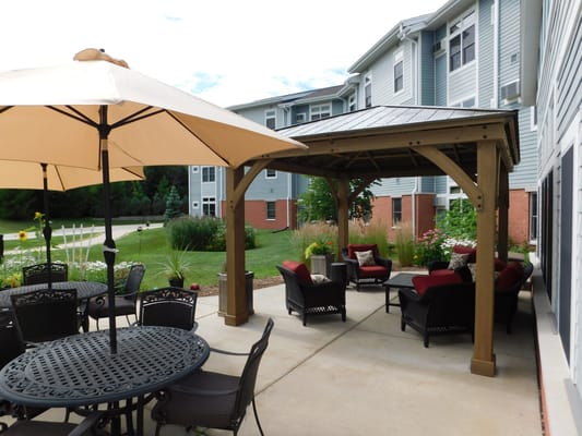 Comfortable outdoor seating area with gazebo and flowers