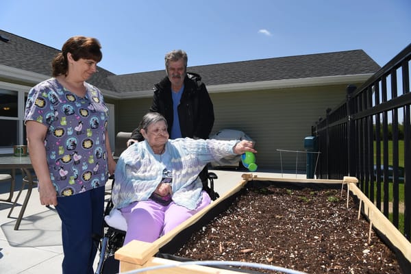 Residents engaging in gardening activity outside