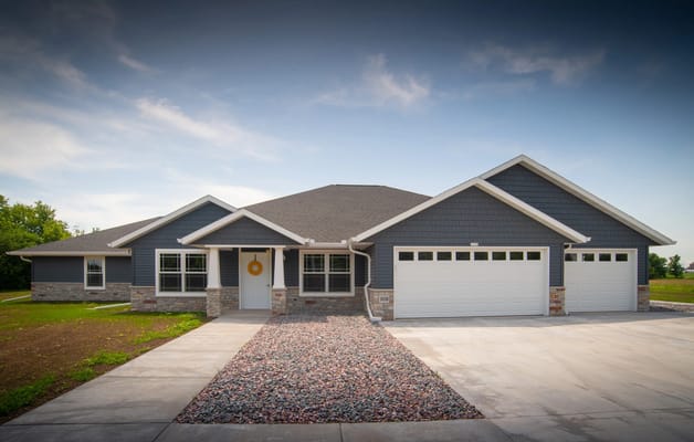 Exterior view of a senior living facility with landscaped yard