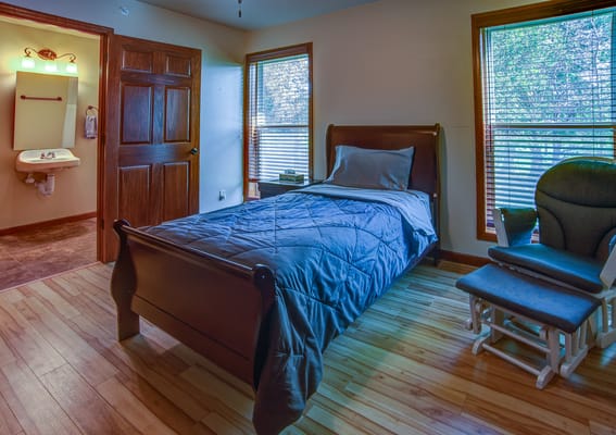 Private resident room with a bed and rocking chair