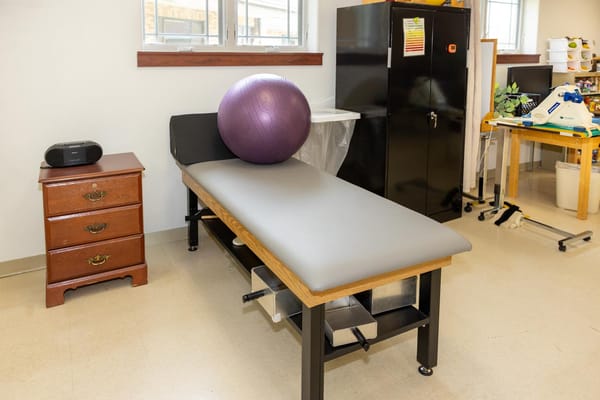 Therapy room with exercise equipment and a fitness ball