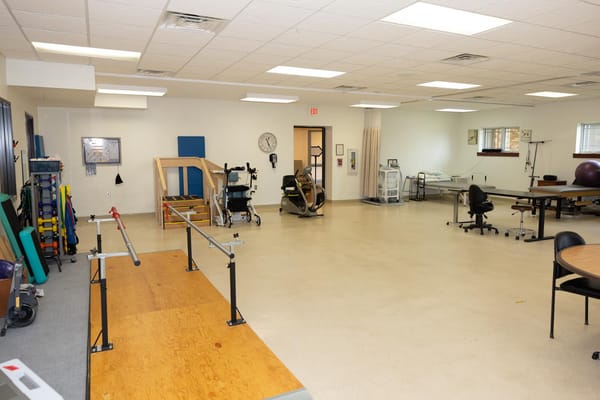 Therapy room equipped with exercise equipment and balance bars
