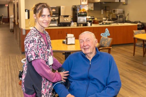 Staff member with a resident in a common area.