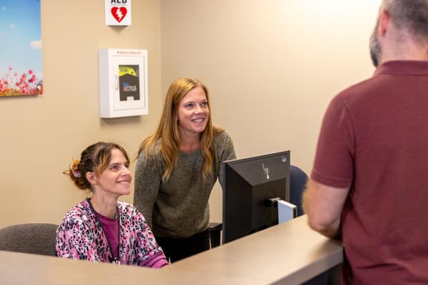 Staff members at the reception desk smiling
