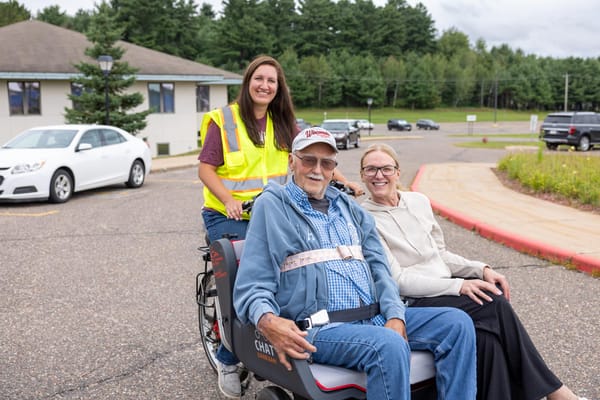 Residents enjoying a ride with staff in an outdoor setting