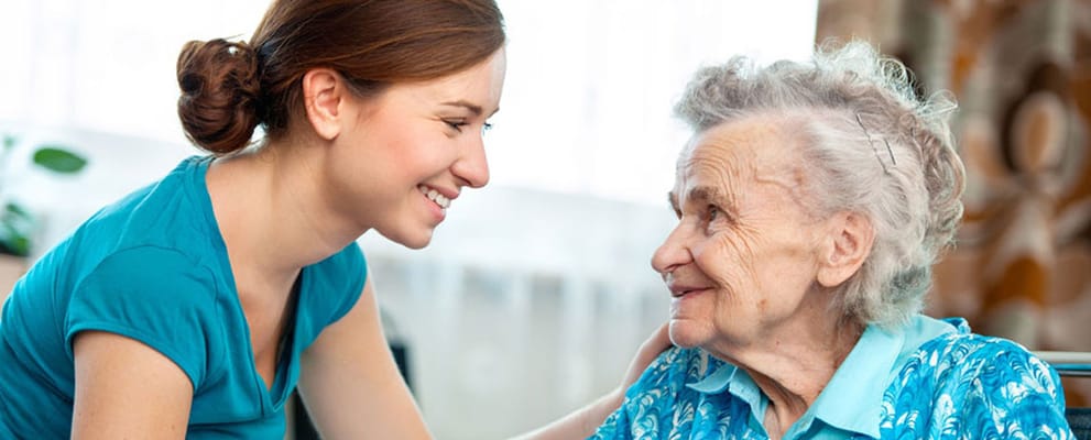 A caregiver interacting with a senior resident