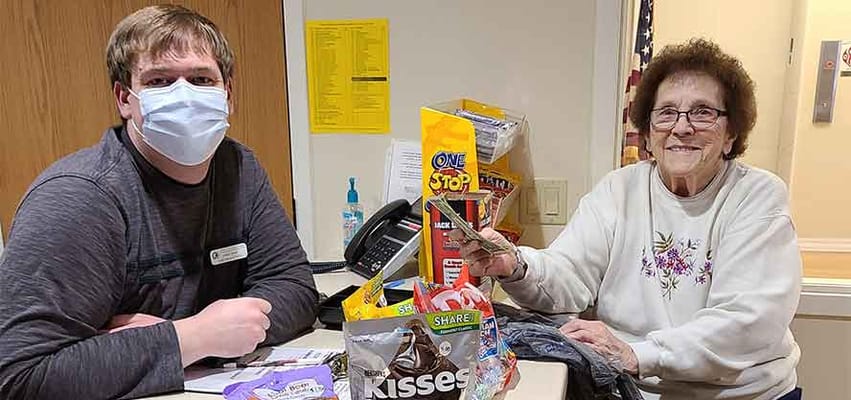 Staff member and resident enjoying treats together