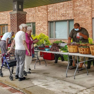 Residents shopping at an outdoor farmer's market