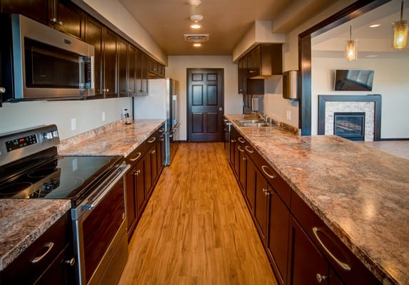 Modern kitchen with dark cabinets and wooden flooring