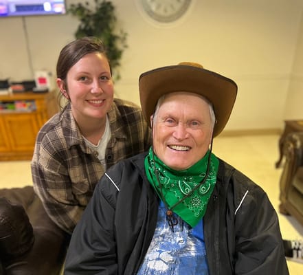 Resident smiling with staff member in common area