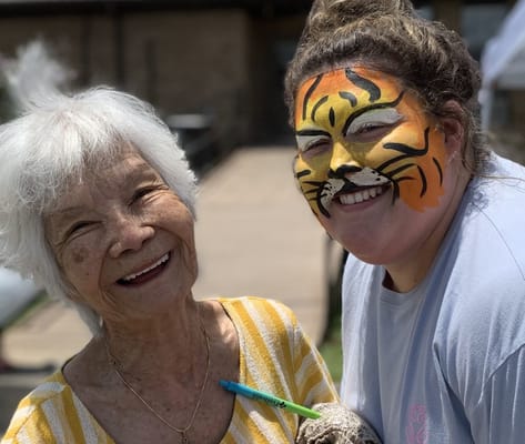 Residents enjoying a fun outdoor activity with face painting