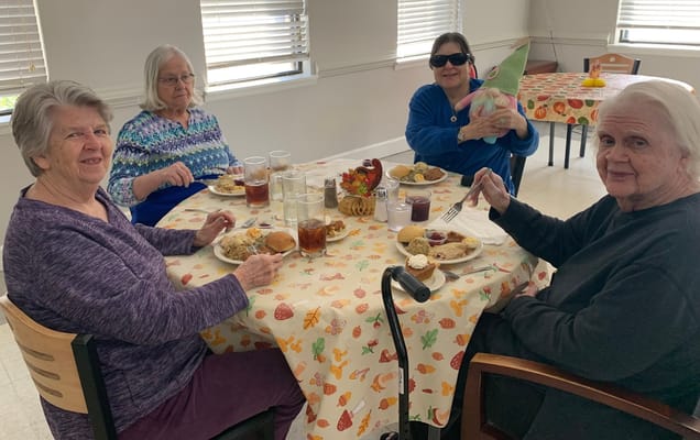 Residents enjoying a meal together in the dining room