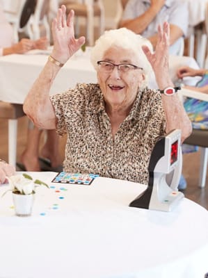 An elderly woman celebrating during a bingo game.