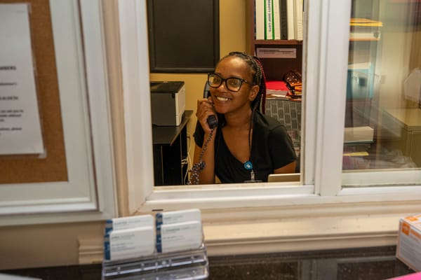 Staff member at the reception desk talking on the phone