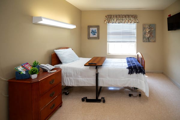 A well-furnished private resident room with a bed and window