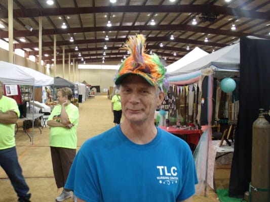 Resident wearing a colorful hat at an event