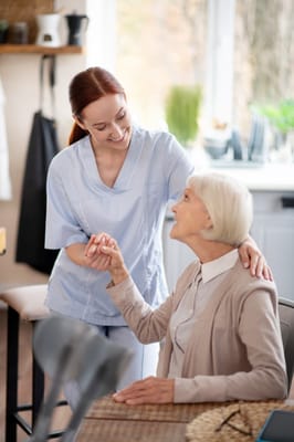 Staff member interacting with a resident in an interior setting