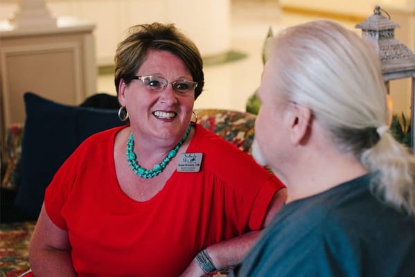 Staff member engaging with a resident in a common area
