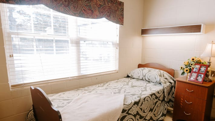 Cozy resident bedroom with a floral bedspread