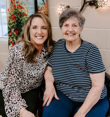 A staff member smiling with a resident in a caring environment