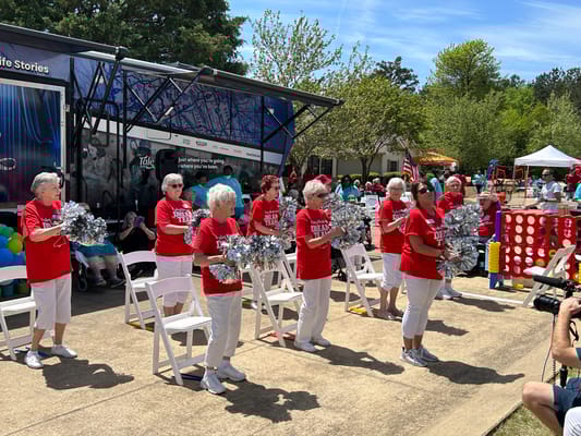 Residents cheerleading during an outdoor activity