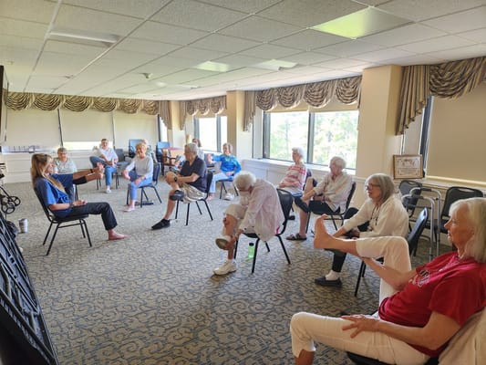 Residents participating in a seated exercise class