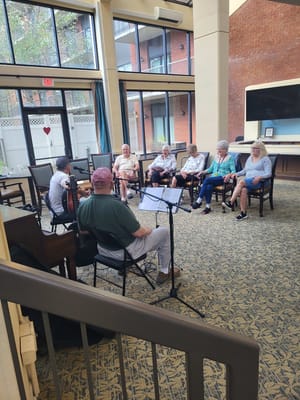 Residents enjoying a live music session in the common area