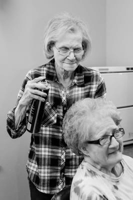 Resident receiving hairstyling in the facility's salon