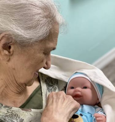 Resident engaging with a lifelike baby doll