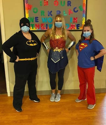 Staff dressed as superheroes in a common area