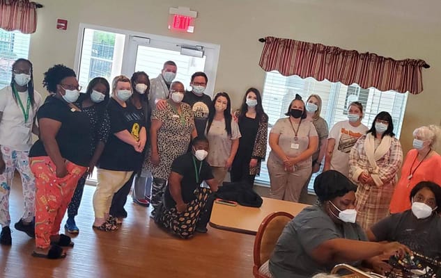 Staff and residents gathered in an activity room