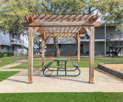 Outdoor pergola with picnic table in a serene setting