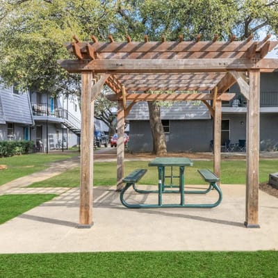 Outdoor seating area with a pergola and picnic table