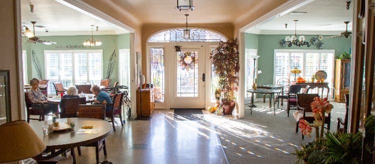 Bright common area with residents engaging in conversation