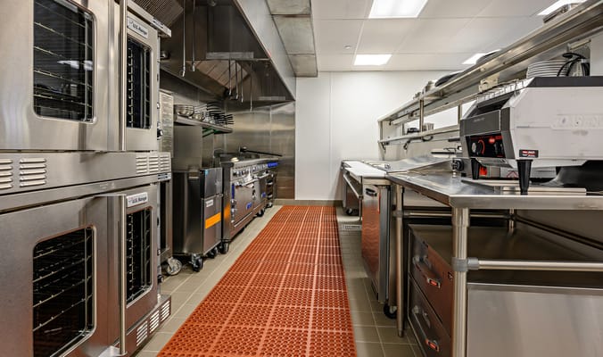 Modern kitchen with stainless steel appliances and equipment