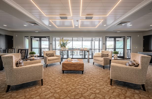Bright common area with chairs and large windows
