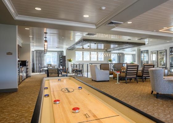 Common area with a shuffleboard and seating