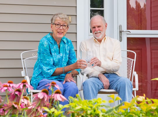 Two residents enjoying drinks on a patio