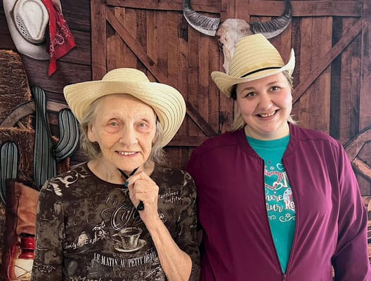 Residents and staff posing together in a festive setting