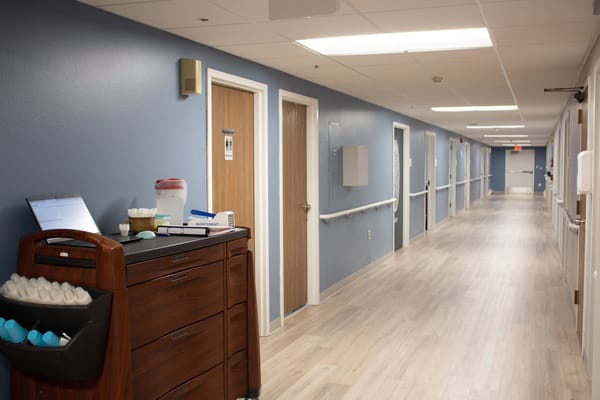 Hallway of a senior care facility with rooms lined