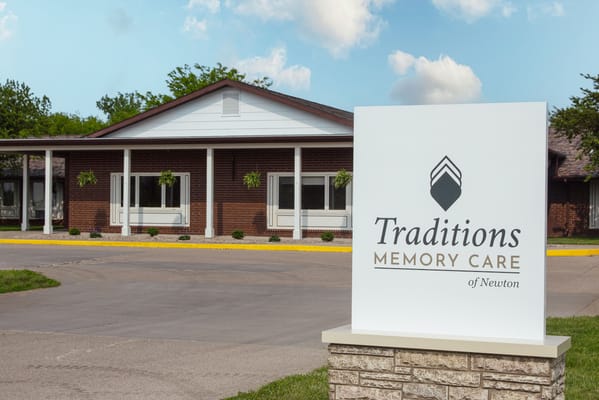 Exterior view of Traditions Memory Care facility sign