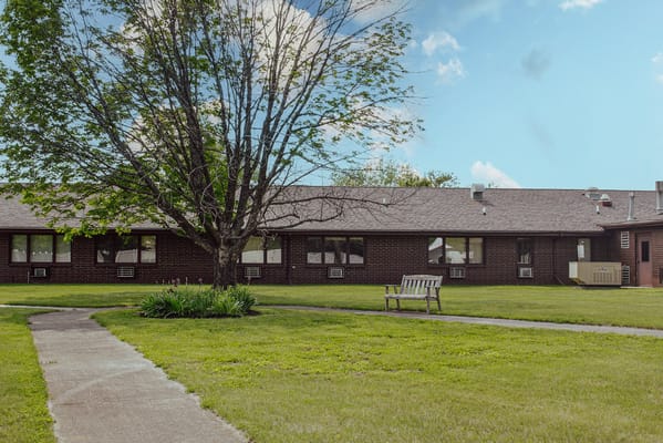 View of a garden area and building exterior at Traditions Memory Care