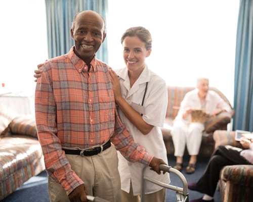Staff member assisting a resident in a common area