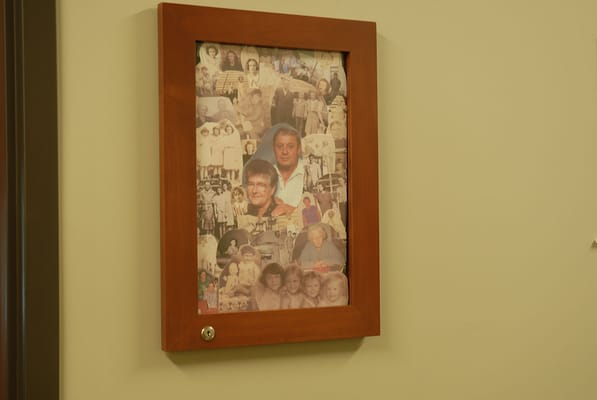Framed display of resident photos on a wall