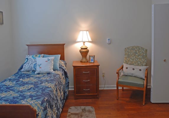 Cozy resident room with bed and lamp